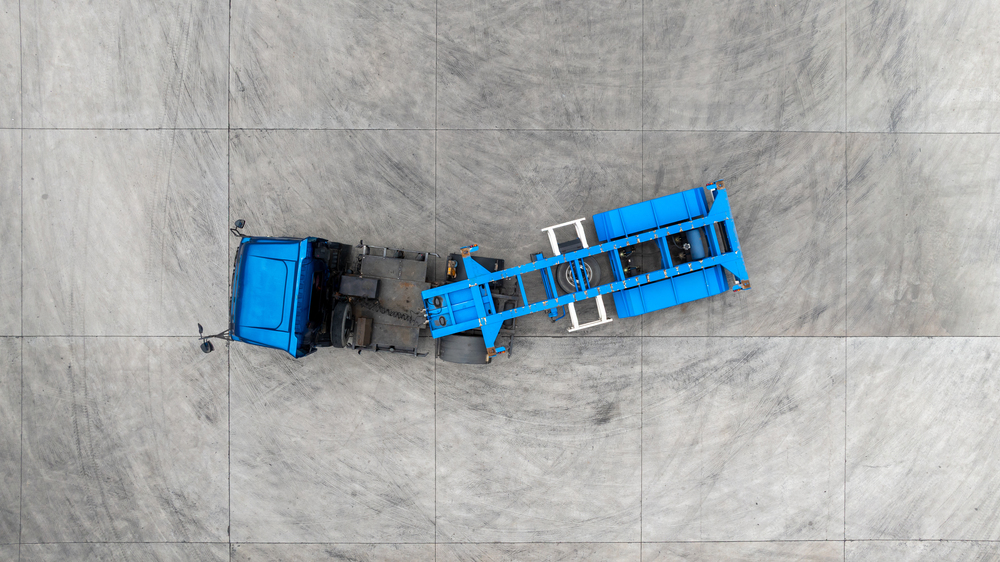 Aerial view semi truck cargo trailer at logistic park warehouse