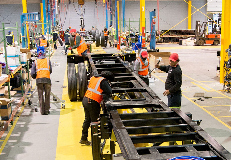 Employees assembling a trailer chassis at CIE