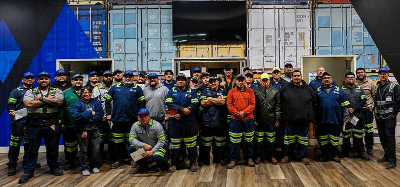 Large group of employees standing together for a team photo